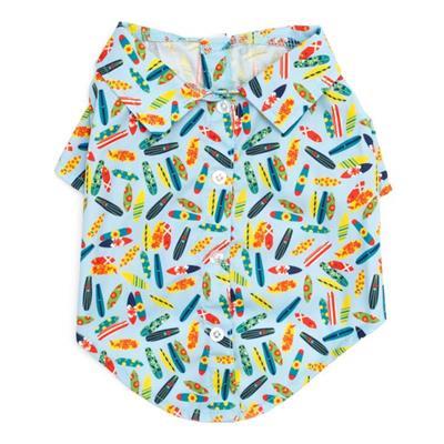 Dog shirt with colorful surfboard pattern on a light blue background