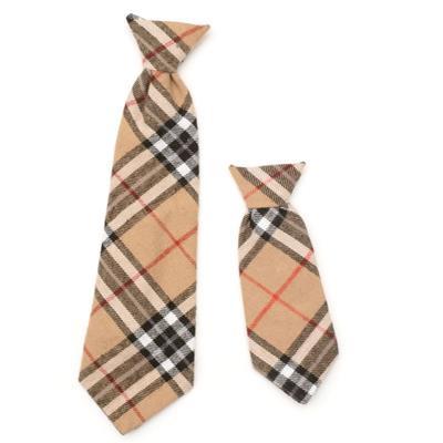 Two plaid patterned dog ties on a white background