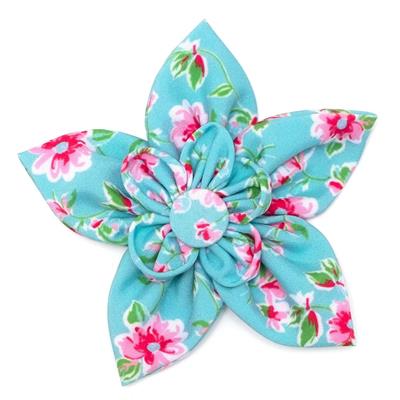 Floral fabric flower with pink and green details on a white background