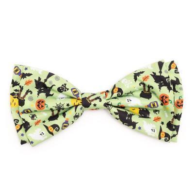 Halloween-themed bow tie with black cats, pumpkins, and ghosts on a light green background.