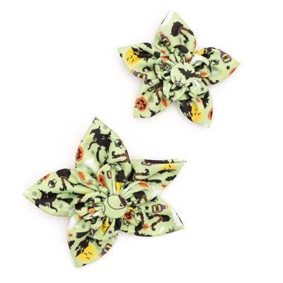 Two Halloween-themed collar bows with pumpkins, cats, and ghosts on a white background.