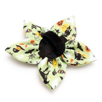 Halloween-themed bow with black cats, pumpkins, and ghosts on a white background