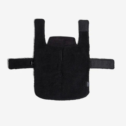 Black fleece interior lining of blanket style dog coat with velcro closures on white background.