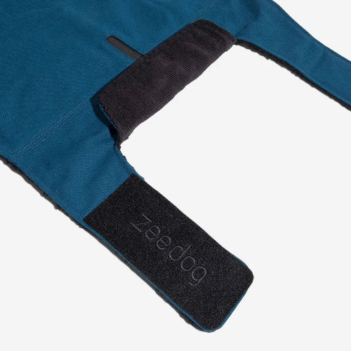 Corduory collar and velcro closure with Zee-Dog branding on blue dog coat on white background.