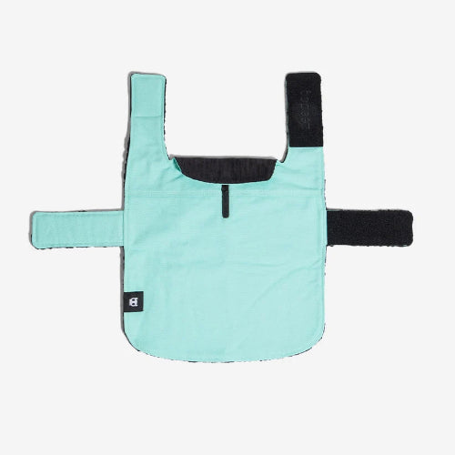 Back view of mint green dog coat with velcro closures, leash hole and Zee.Dog logo on white background.