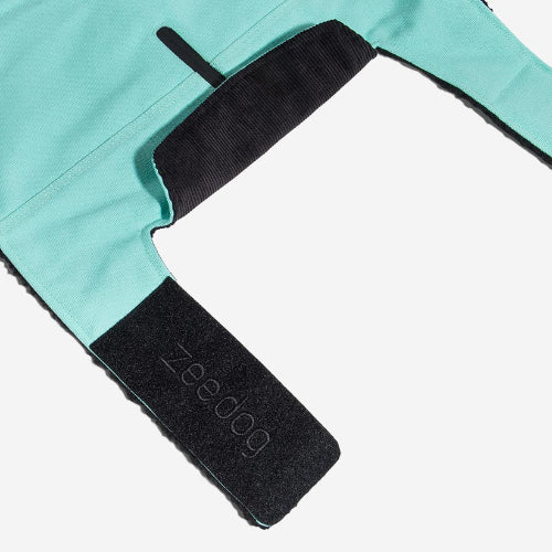 Corduroy collar and velcro closure of mint green blanket style dog coat on white background.