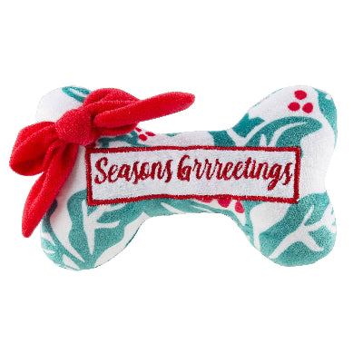 Dog toy with 'Seasons Greetings' label and red bow on a white background