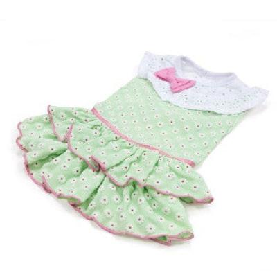 Green polka dot dress with pink trim and bow on a white background