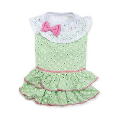 Green polka dot dress with a pink bow on a white background