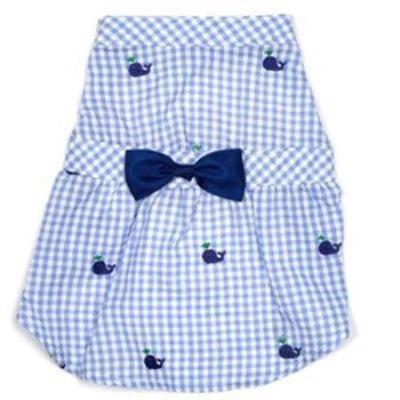 Blue gingham pet dress with whale patterns and a bow tie on a white background