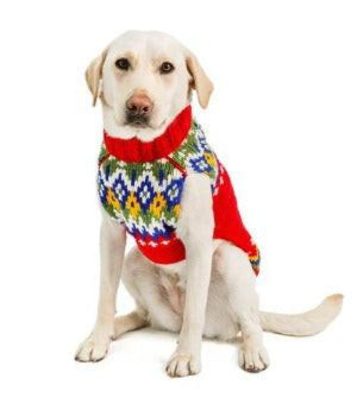 Yellow Labrador wearing a hand-knit red and multi-colored Fairisle wool sweater with a ribbed turtleneck on white background
