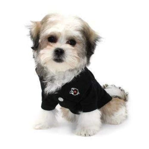 Small dog wearing a jet black cotton polo shirt with a buttoned collar and embroidered logo on a white background.