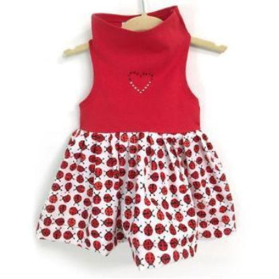 Red top and ladybug patterned shirt on a hanger against a white background