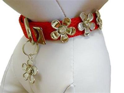 White dog mannequin wearing red dog collar with silver flowers on white background