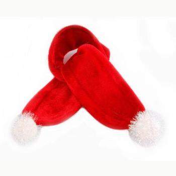 The Santa Paws Scarf by Pooch Outfitters, a red, plush scarf with white pom-poms on the ends, lies elegantly overlapped on a light background, showcasing the charm of a holiday pet accessory.