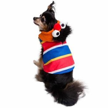 Small dog wearing a soft, striped Ernie hoodie with an attached character hood featuring eyes and a nose.